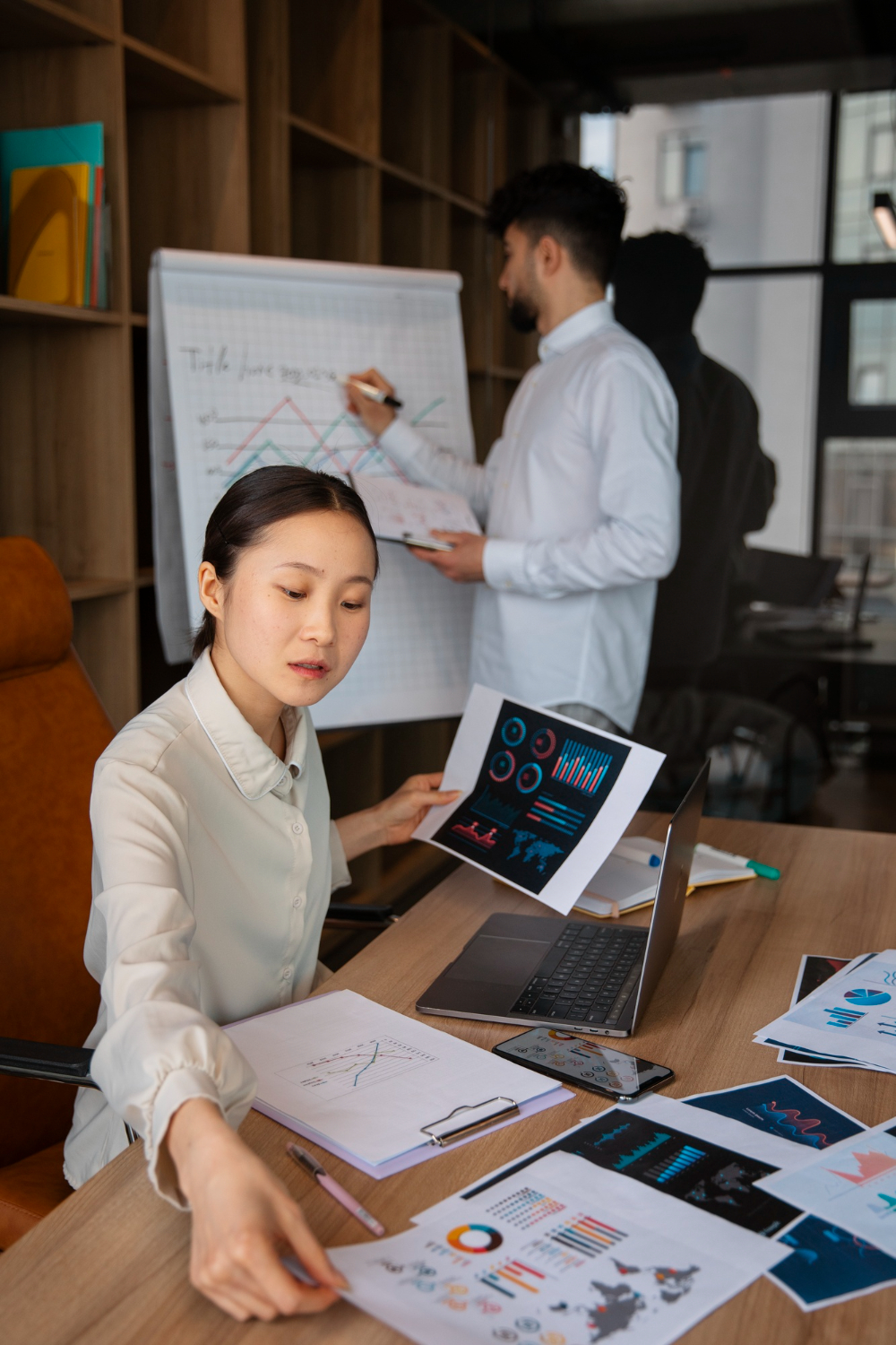 Office workers using finance graphs